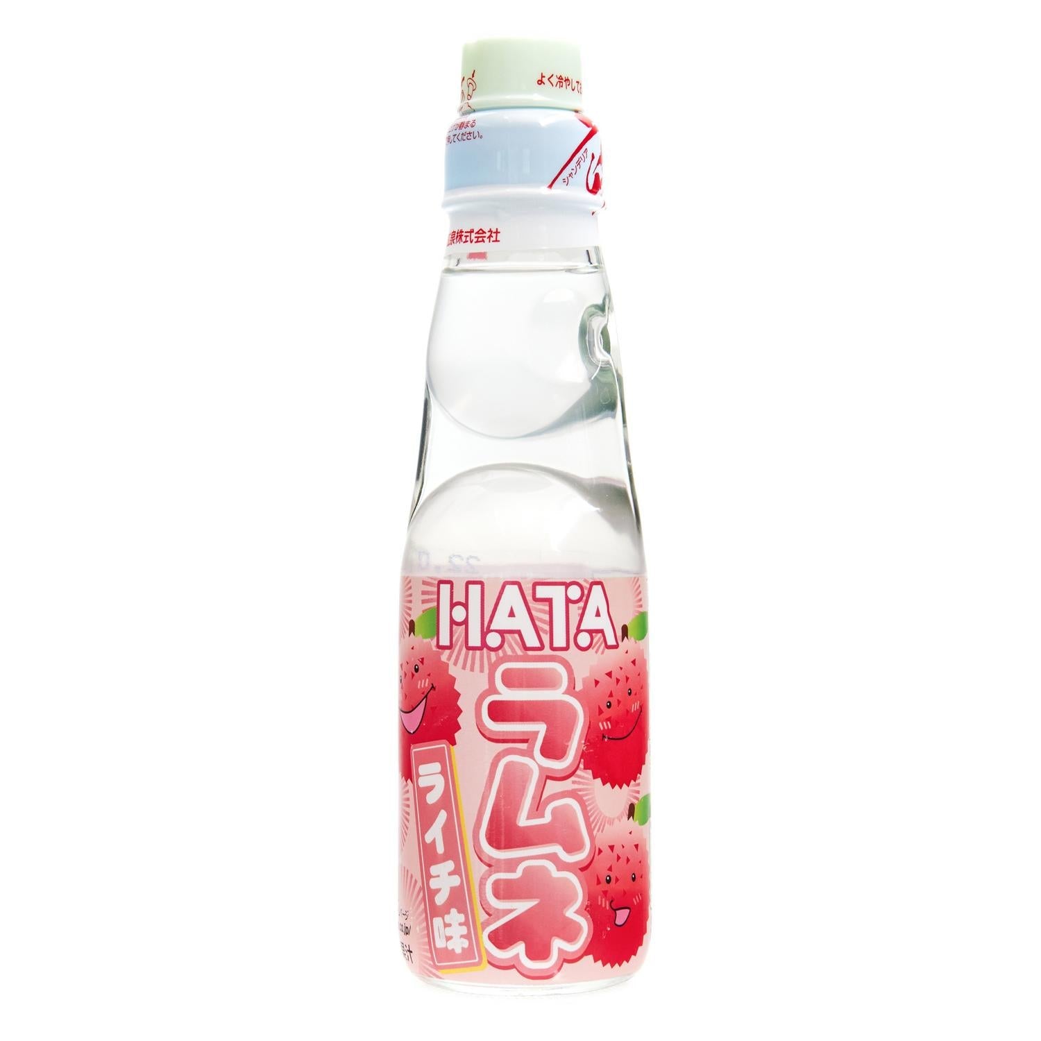A clear glass bottle of Hatakosen Ramune Lychee with red lychee fruit images and Japanese text on the label.