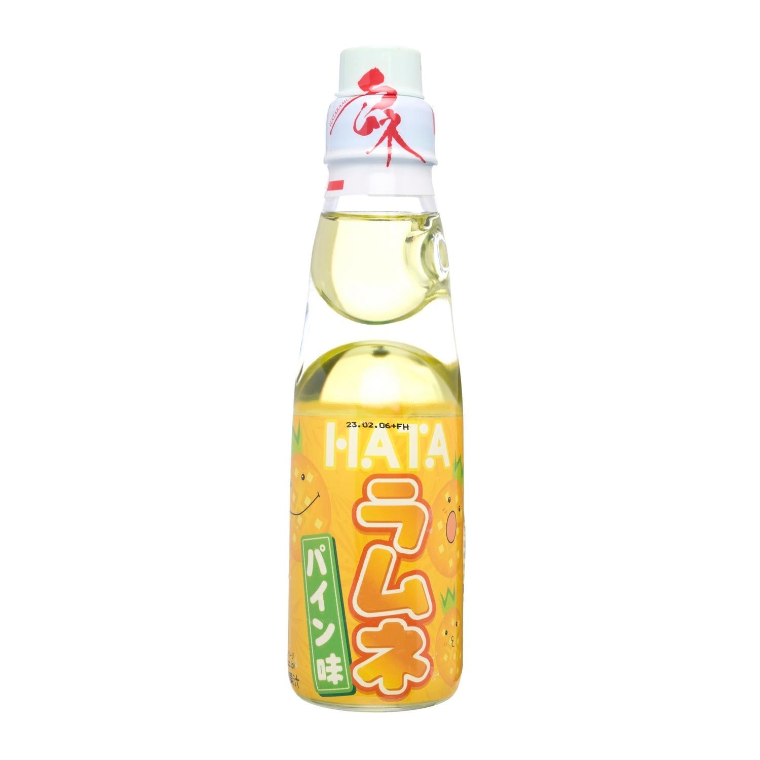 Glass bottle of Japanese Ramune soda with pineapple flavor, marble seal, and yellow-themed label.