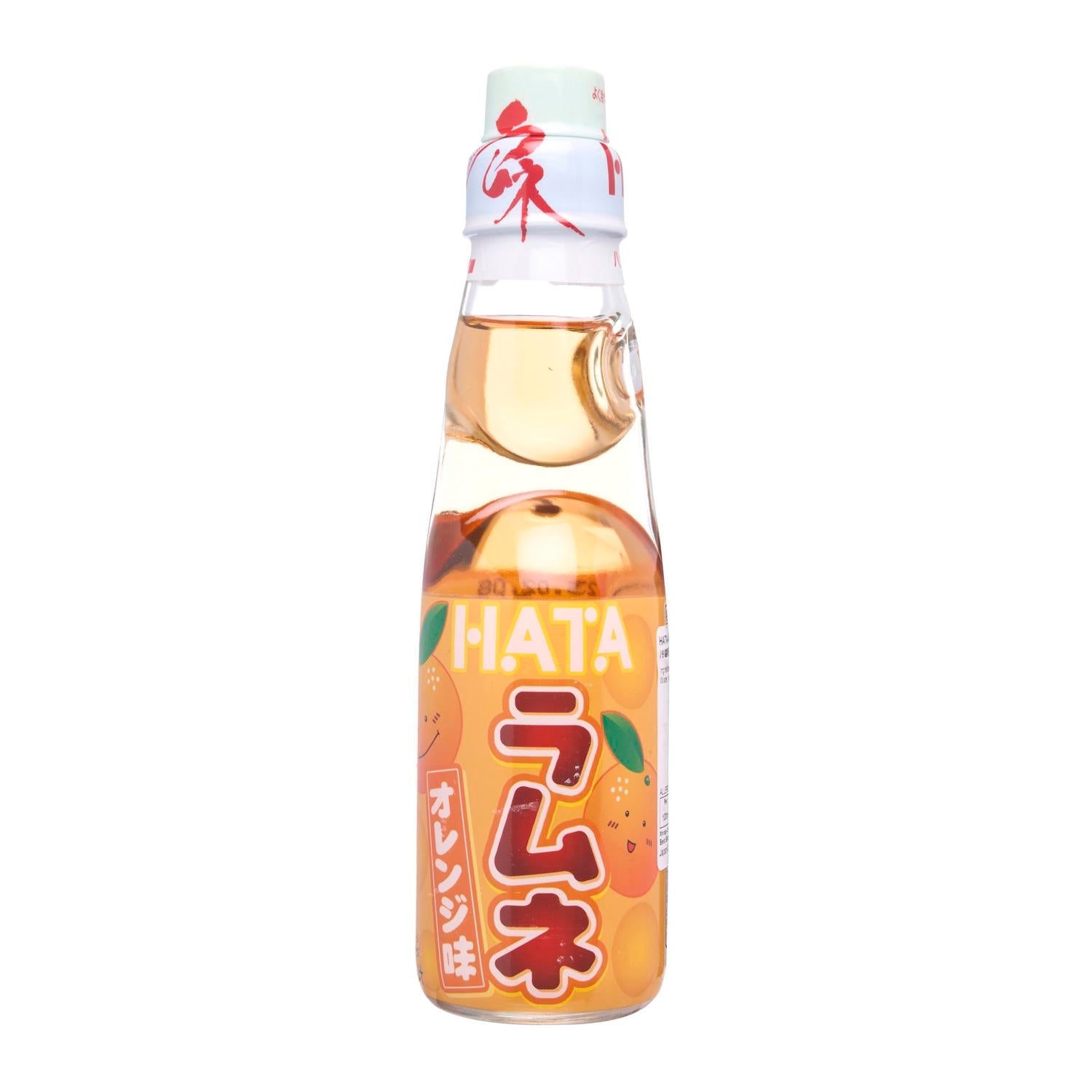 A glass bottle of Hatakosen Ramune Orange with a clear liquid and orange color, labeled in Japanese and English, with a cap and decorative elements on the label.